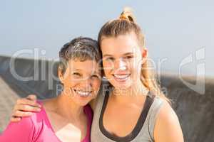 Sporty mother and daughter smiling