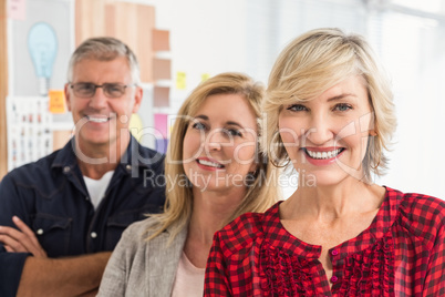 Smiling business team looking at the camera