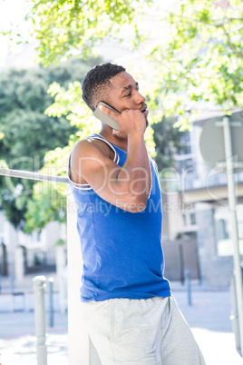 An happy handsome athlete calling