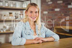 Smiling blonde sitting and looking at camera