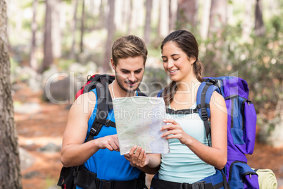 Happy hikers looking at map