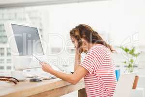Tired casual businesswoman working with tablet
