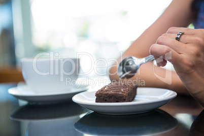 Woman eating a chocolate brownie