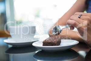 Woman eating a chocolate brownie
