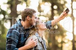 Happy smiling couple embracing and taking selfies