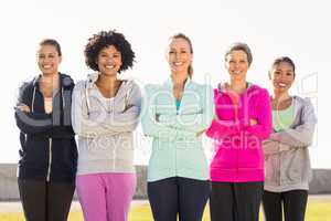 Smiling sporty women with arms crossed