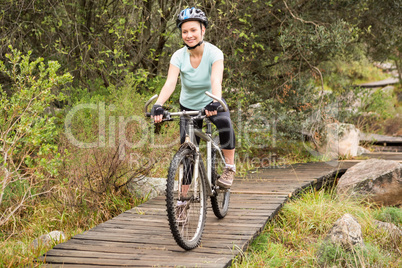 Smiling fit woman cycling her bike