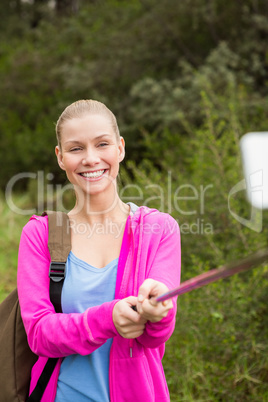 Smiling female hiker taking a selfie