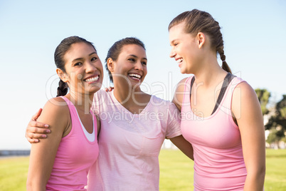 Smiling woman and friends wearing pink for breast cancer