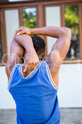 An handsome athlete stretching