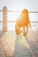 Fit woman tying her shoelace at promenade