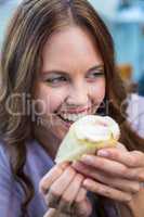 Pretty brunette enjoying a cake