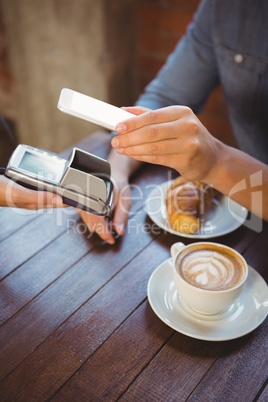 Male customer paying with smartphone