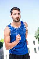 Focused handsome athlete jogging