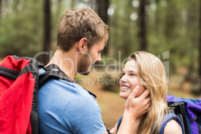 Young happy hiker couple looking at each other