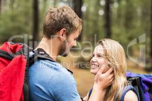 Young happy hiker couple looking at each other