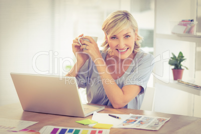 Smiling businesswoman working on a laptop