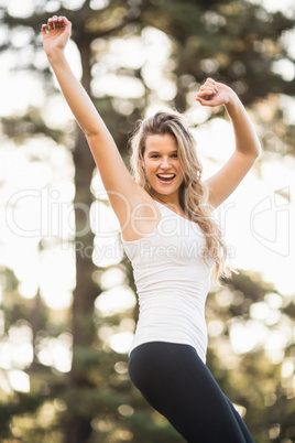 Young happy jogger dancing and looking at the camera