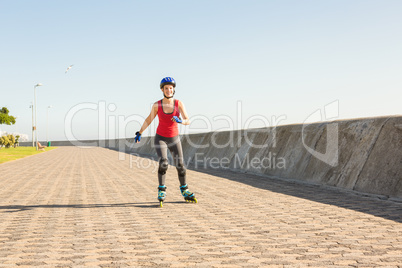 Smiling sporty blonde skating