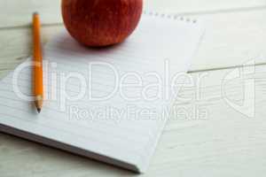 View of an apple and notepad