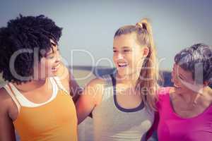 Sporty women smiling at each other