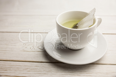 Cup of herbal tea on table