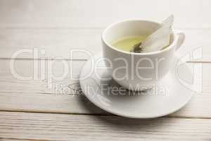 Cup of herbal tea on table