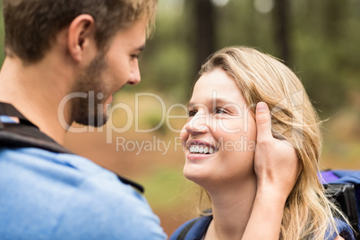 Young happy hiker couple looking at each other