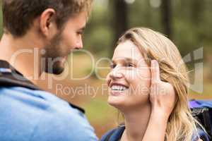 Young happy hiker couple looking at each other