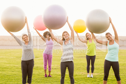 Smiling sporty women working out with exercise balls