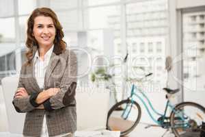 Smiling casual businesswoman with arms crossed