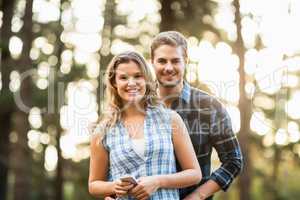 Happy smiling couple standing behind each other