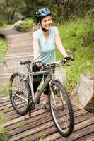 Smiling fit woman rolling her bike
