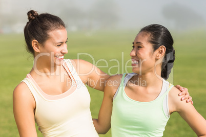 Smiling sporty women looking at each other