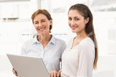 Smiling businesswomen with laptop