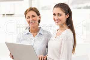 Smiling businesswomen with laptop