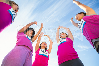 Five cheering runners supporting breast cancer marathon