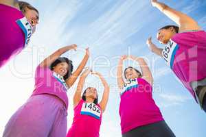 Five cheering runners supporting breast cancer marathon