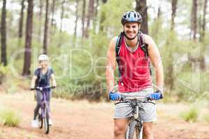 Happy young biker couple looking at camera