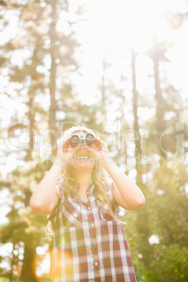 Pretty young blonde looking through binoculars