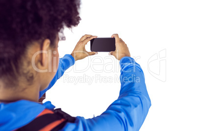 Young woman with backpack taking picture