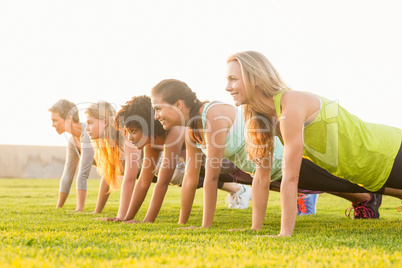 Sporty women doing push ups during fitness class