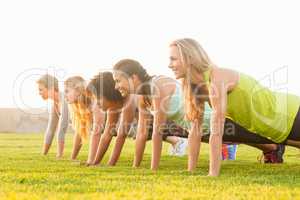 Sporty women doing push ups during fitness class