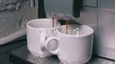Coffee Machine Making Espresso into a Two Cap, closeup