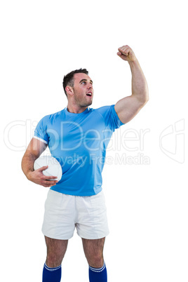 Rugby player cheering with the ball