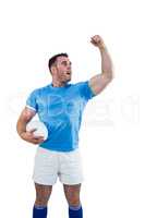 Rugby player cheering with the ball