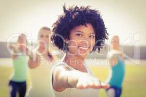 Smiling sporty woman doing yoga in yoga class
