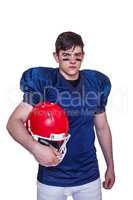 American football player holding an helmet
