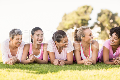 Smiling women lying in a row and wearing pink for breast cancer