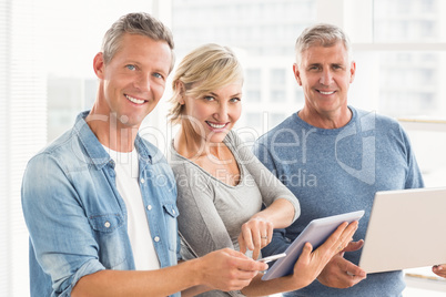 Smiling business colleagues using electronic devices